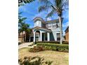 Beautiful two-story home featuring a landscaped yard, arched entryway and a side entry garage at 1030 Marcello Blvd, Kissimmee, FL 34746