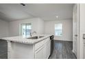 Kitchen island offering granite countertops and a breakfast bar in an open-concept layout at 181 Cimarron Ln, Poinciana, FL 34759