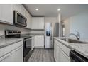 Stylish kitchen boasting granite countertops, stainless appliances, and ample cabinet space at 181 Cimarron Ln, Poinciana, FL 34759