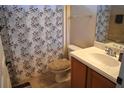 Clean, neutral bathroom with a single sink vanity, tile flooring, and a shower-tub combo at 1886 Van Gogh Dr, Auburndale, FL 33823