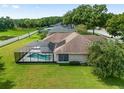 Aerial view of a backyard with a screened-in pool and lush green grass at 5060 Se 40Th St, Ocala, FL 34480