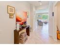Bright entryway with tile floors, decorative table, and a view into the living area at 518 Cortez Dr, Davenport, FL 33837