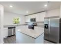 Modern kitchen featuring stainless steel appliances, granite countertops and an island at 576 Bay Leaf Dr, Poinciana, FL 34759