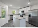 Modern kitchen featuring stainless steel appliances, granite countertops and an island at 576 Bay Leaf Dr, Poinciana, FL 34759
