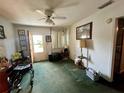 A traditional living room featuring a ceiling fan and carpeted flooring at 606 El Vedado Ave, Orlando, FL 32807
