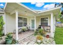 Covered back porch perfect for relaxing with outdoor seating and plants at 830 Polk St, Orlando, FL 32805