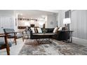 Open-concept living room with modern furnishings, a plush sofa, stylish decor, and a view of the kitchen at 3008 Protagonist St, Kissimmee, FL 34746