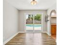 Bright dining area with a view of the pool, wood-look tile floor, and seamless flow into the kitchen at 520 Hamlet Dr, Port Orange, FL 32127