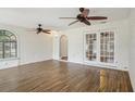 Spacious room with wood-look tile floors, white textured walls, and french doors to the backyard at 520 Hamlet Dr, Port Orange, FL 32127