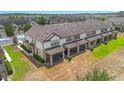 Aerial view shows townhome exteriors with screened patios and lush green landscaping at 1101 Pavia Dr, Apopka, FL 32703