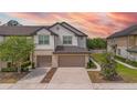 Townhome exterior showcases two-car garage, charming curb appeal, and well-maintained surroundings at 1101 Pavia Dr, Apopka, FL 32703