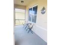 Covered front porch with a seating area to create a welcoming outdoor space to relax in at 159 Lazy Willow Dr, Davenport, FL 33897