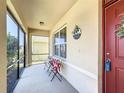 Inviting screened porch with chairs and a welcome sign, perfect for relaxing outdoors at 159 Lazy Willow Dr, Davenport, FL 33897