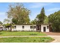 Inviting single-story home with a well-manicured lawn and mature trees in a peaceful neighborhood setting at 2013 Pineway Dr, Orlando, FL 32839