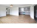 Open-concept living space featuring hardwood floors and an abundance of natural light from a large window at 2013 Pineway Dr, Orlando, FL 32839