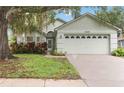 Well-maintained single-story home with large two-car garage and mature landscaping in front at 13219 Meadowlark Ln, Orlando, FL 32828