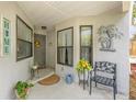 Inviting front porch decorated with plants and a cozy seating area, offering a warm welcome at 640 Lake Dexter Cir, Winter Haven, FL 33884