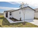 Charming single-story home with a pristine white garage door and a freshly landscaped front yard at 2530 Linda Knoll Ln, Bartow, FL 33830
