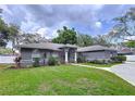 Lovely one-story home with a neatly kept lawn, arched windows, and a welcoming front entrance at 1634 Lady Bowers Trl, Lakeland, FL 33809