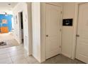 Well-lit hallway with tiled flooring, leading to rooms with inviting decor and a calming atmosphere at 2987 Neverland Dr, New Smyrna Beach, FL 32168