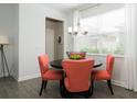 Bright dining area featuring a round table, coral-colored chairs, chandelier, and a large window at 3013 Howley Aly, St Cloud, FL 34771