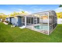 Private backyard features a screened-in pool and a well-maintained lawn at 2216 Heathwood Cir, Orlando, FL 32828