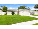 Charming single-story home with green lawn and an attached two-car garage at 408 S Edgemon Ave, Winter Springs, FL 32708