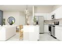 Open-concept living space with modern kitchen and inviting seating area at 2637 Skyline Loop, Kissimmee, FL 34758