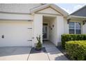 Inviting home entrance showcasing a well-kept lawn and meticulously cared for landscaping at 3017 Country Club Cir, Winter Haven, FL 33881