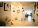 Bright hallway adorned with decorative wreaths and wall art, leading to various rooms at 3017 Country Club Cir, Winter Haven, FL 33881