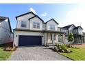 Beautiful two-story home with a large driveway and manicured landscaping at 16994 Cedar Valley Cir, Clermont, FL 34711