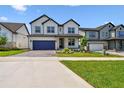 Charming two-story home with landscaped yard, stone accents, and brick paved driveway at 16994 Cedar Valley Cir, Clermont, FL 34711
