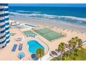 Oceanfront pool deck with pool, lounge chairs, hot tub, tennis courts, and beach access at 2625 S Atlantic Ave # 24Sw, Daytona Beach, FL 32118