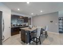 Well-equipped kitchen featuring granite countertops, a center island with seating, and stainless steel appliances at 9532 Black Walnut Dr, Clermont, FL 34715