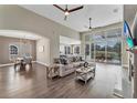 Spacious living room is filled with natural light, features wood floors, and is open to the dining and kitchen at 1530 The Oaks Blvd, Kissimmee, FL 34746