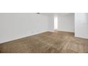 Open-concept living room with beige carpeting and white paint throughout at 2425 Anderson, Mulberry, FL 33860