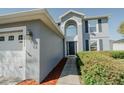 Beautiful exterior showcasing the front entrance and attached two-car garage of the home at 1808 Ashton E Dr, St Cloud, FL 34771