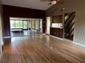 Spacious living room featuring hardwood floors, neutral walls, and sliding glass doors to the patio at 3050 Carolina Ave, Lakeland, FL 33803