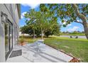 Backyard patio area with seating and a view of the pond, enhancing the property's outdoor living space at 1322 Aguacate Ct, Orlando, FL 32837