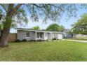 Lovely one-story home with a green lawn, an attached one-car garage, and mature trees at 14464 Sw 34Th Terrace Rd, Ocala, FL 34473
