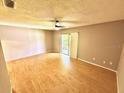 Bedroom features wood floors, neutral walls, and access to a balcony through sliding doors at 296 Lewfield Cir, Winter Park, FL 32792