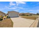 Well-kept single-Gathering home with a spacious driveway, a two-car garage, and well-maintained landscaping at 3184 Whispering Trails Ave, Winter Haven, FL 33884