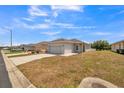 Lovely single-Gathering home featuring a spacious yard, a two-car garage, and classic architectural details at 3184 Whispering Trails Ave, Winter Haven, FL 33884