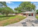Lovely single-story brick house with red shutters and attached carport at 1123 Enchanted Dr, Lakeland, FL 33801