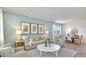 Bright living room with stylish decor, a comfortable sofa, and an adjacent dining area at 2853 Haze Rd, Clermont, FL 34714