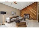 Cozy living room features a decorative fireplace, a sectional sofa, and stylish decor at 3807 Timberlake N Rd, Lakeland, FL 33810
