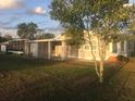 Large backyard featuring mature trees, a screened-in porch and covered patio at 149 County Road 640, Lake Wales, FL 33859
