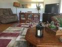 Inviting living room with rich wood floors, neutral walls, and comfortable furnishings at 149 County Road 640, Lake Wales, FL 33859