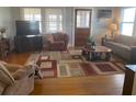 Cozy living room with hardwood floors, area rug and comfortable seating arrangement at 149 County Road 640, Lake Wales, FL 33859