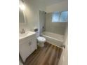 Updated bathroom with a shower-tub combo, new flooring, a modern vanity, and a tile surround at 1727 Bonita Ave, Orlando, FL 32805